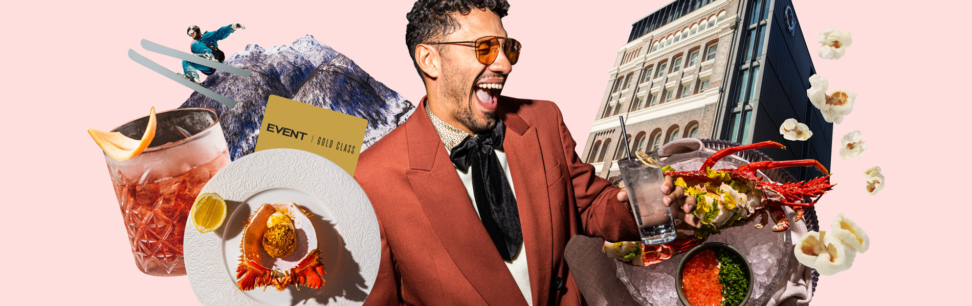 Smiling man in a red suit surrounded by plated food, drinks, herbs, and a city building on a pink background.